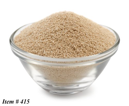 Dry yeast granules in glass bowl isolated on white